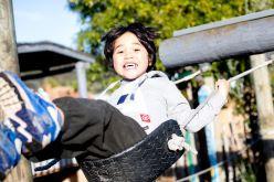 Image of student on outdoor swing.