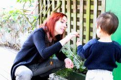 Teacher with child and plants.